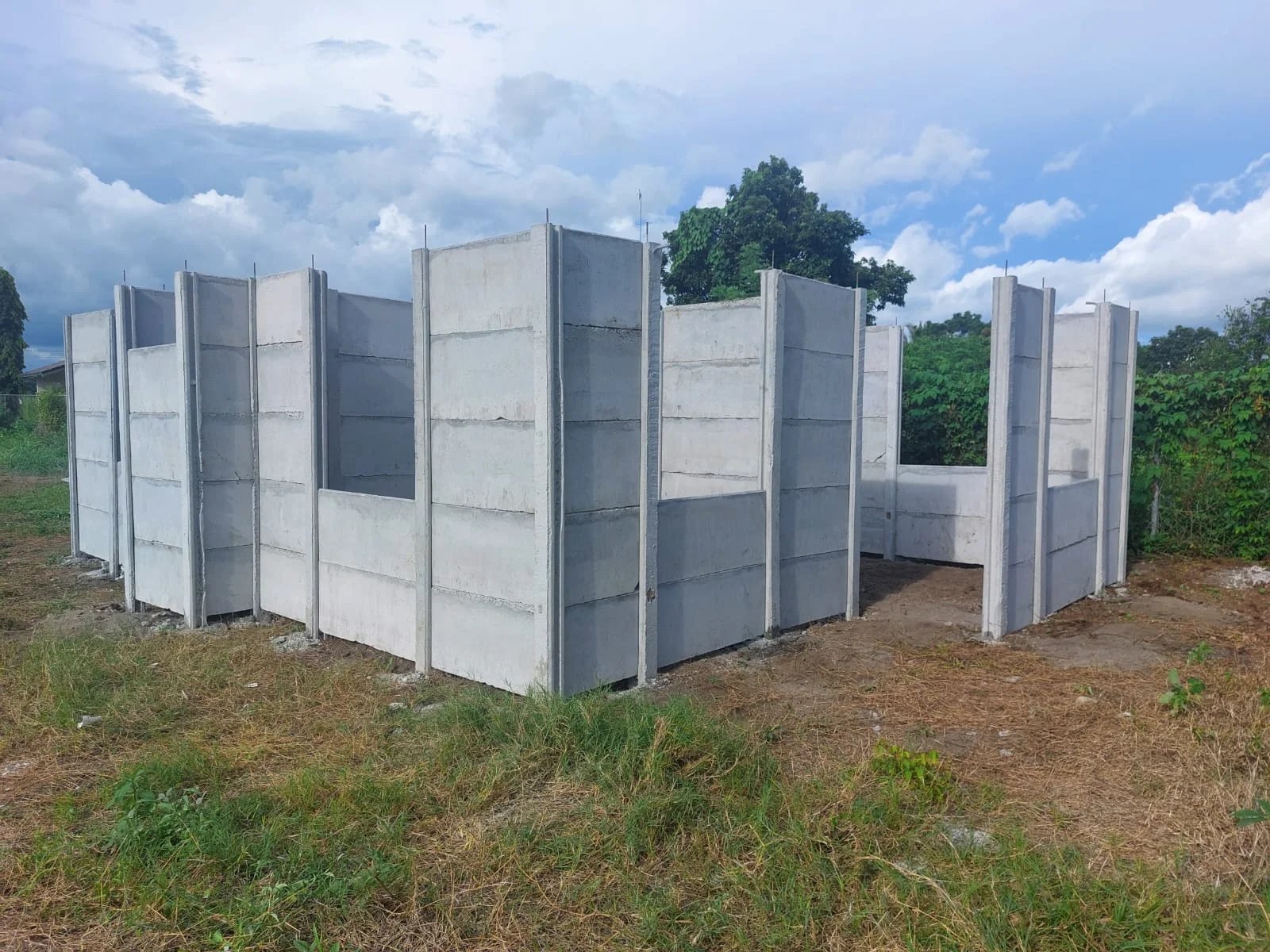 Estructura de casa prefabricada armada en lote vacío con vegetación natural alrededor